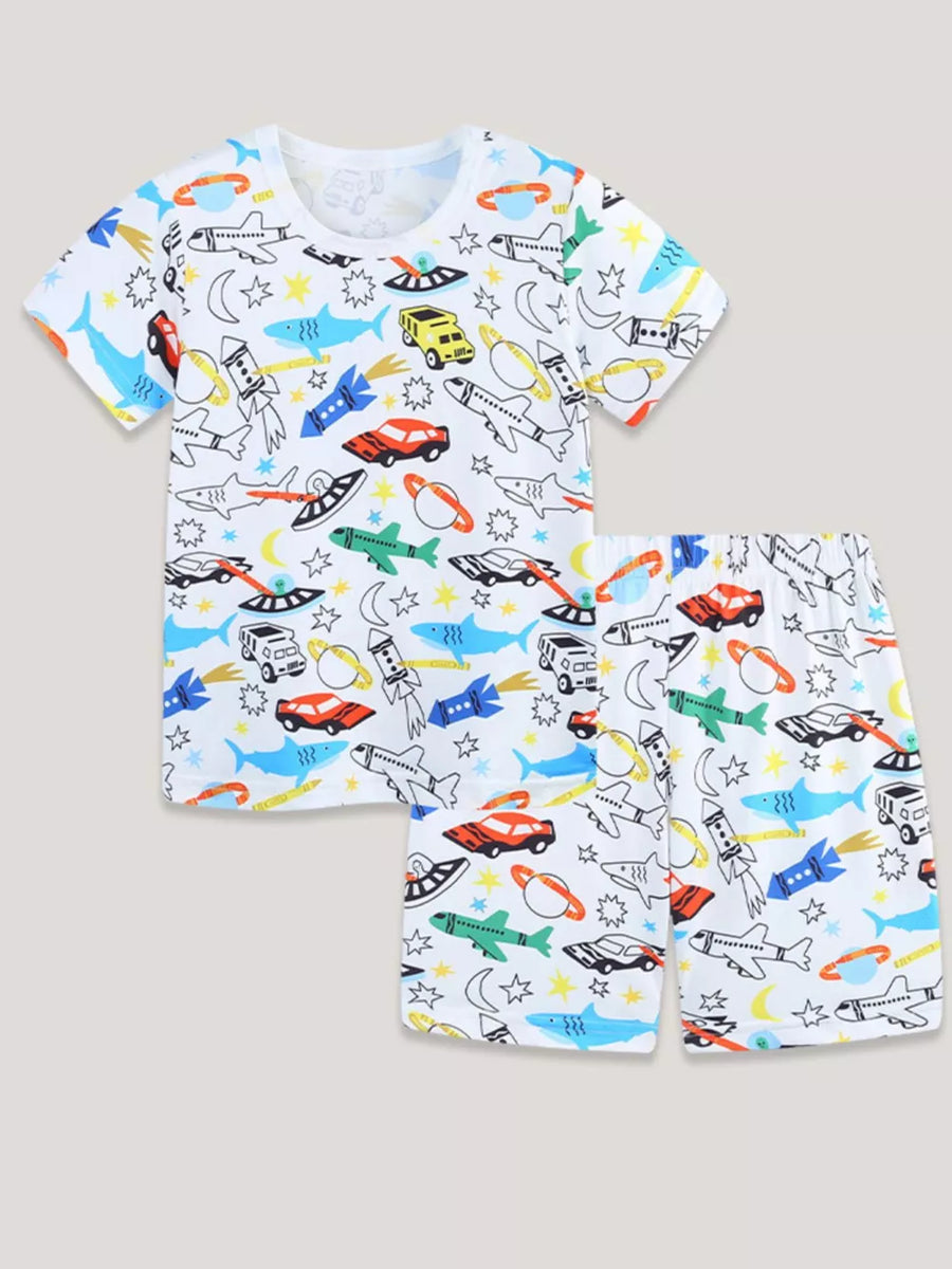 White toddler pajama set with vehicles, rockets, planes, sharks, and planets print.
