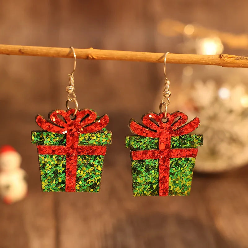Green glitter gift box drop earrings with red ribbon detail.