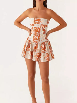 Ruffled tube dress in floral print with a cinched waist and flared skirt.