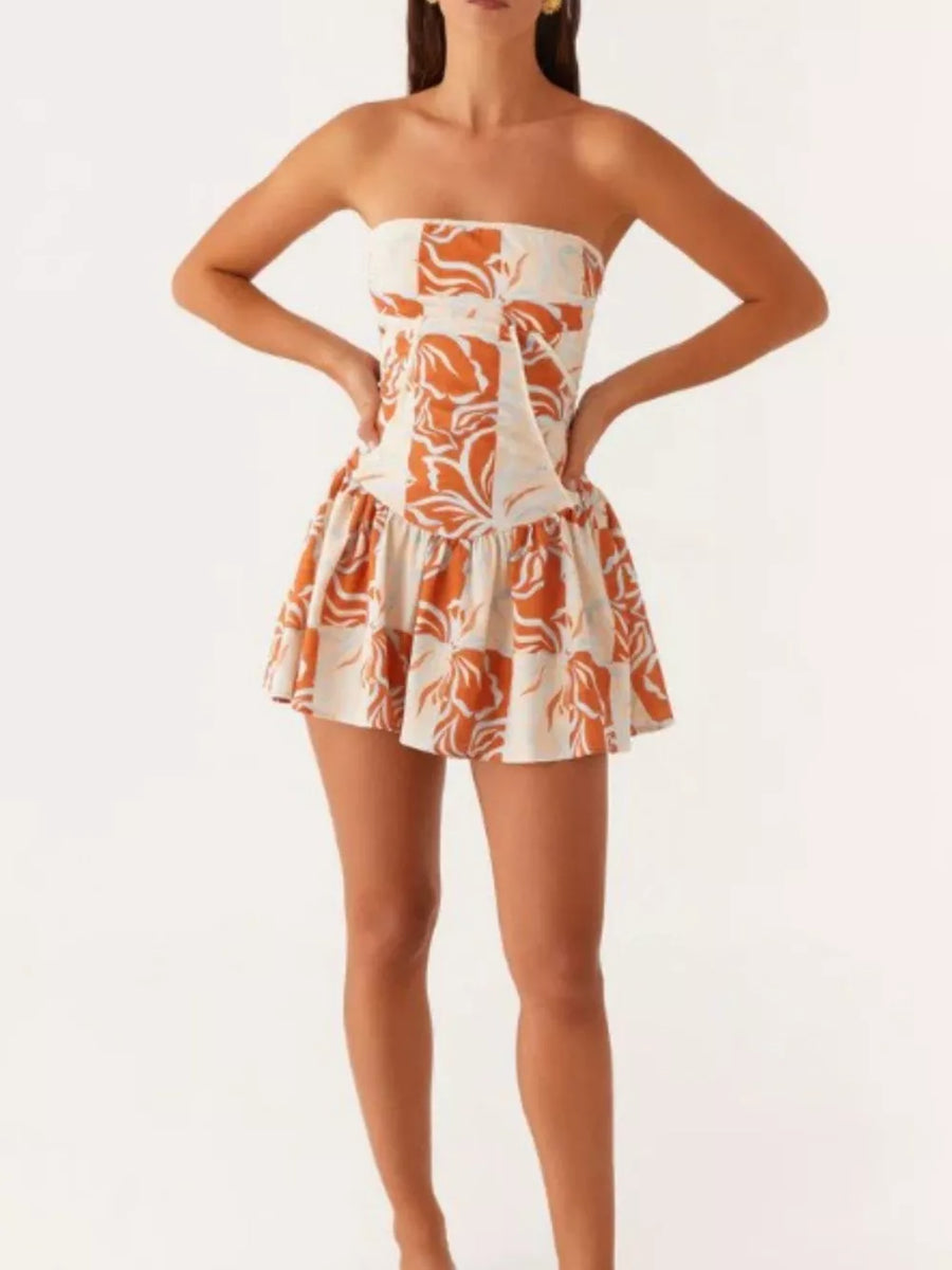 Ruffled tube dress in floral print with a cinched waist and flared skirt.
