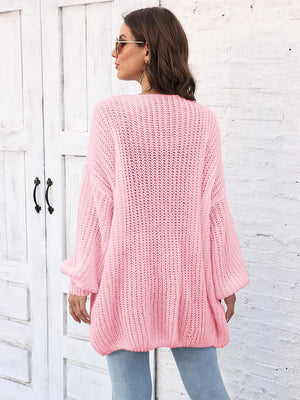 Blush pink open knit cardigan with balloon sleeves and ribbed texture.