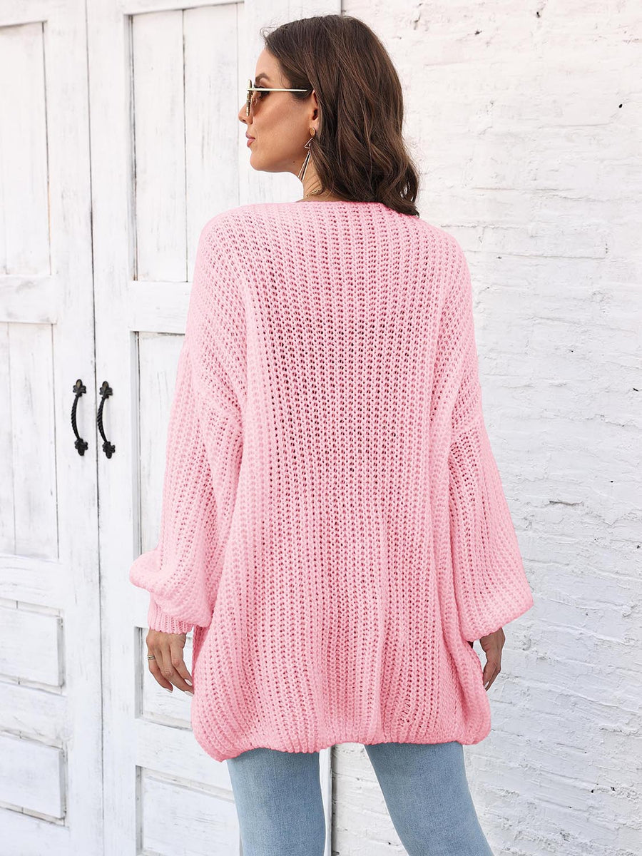 Blush pink open knit cardigan with balloon sleeves and ribbed texture.
