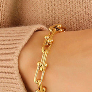Gold sculptural link chain bracelet with bead accents, 18k gold-plated.