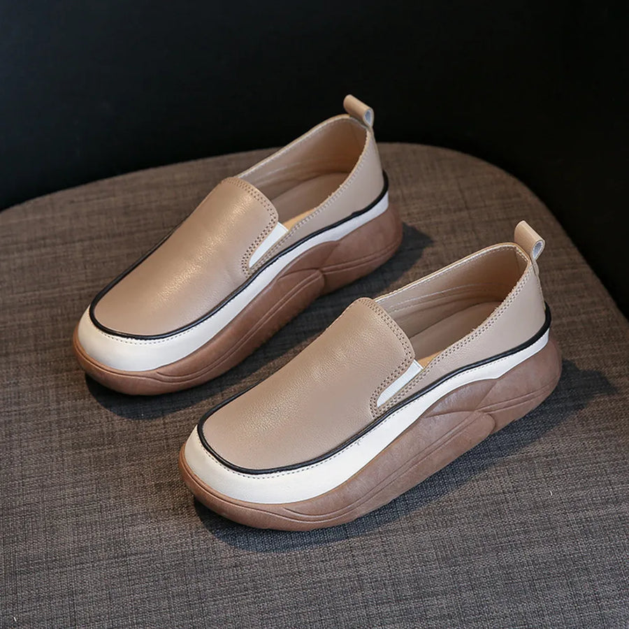 Khaki slip-on sneakers with sculpted platform sole and white and black trim detail.