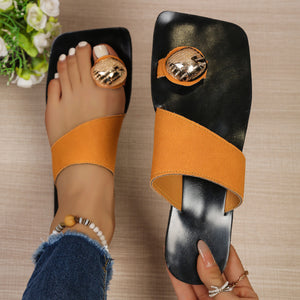 Chic square toe ring sandals in black with orange asymmetric strap and gold accent.