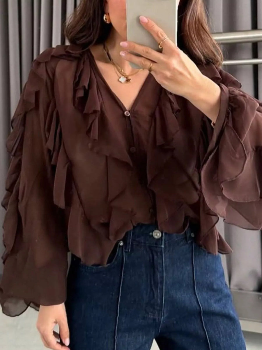 Brown sheer long-sleeve blouse with ruffled details and V-neck.