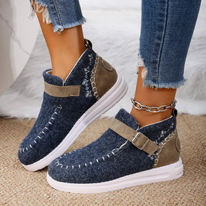 Textured stitch-detail buckle sneakers in dusty blue with embroidered accents and a tan strap.