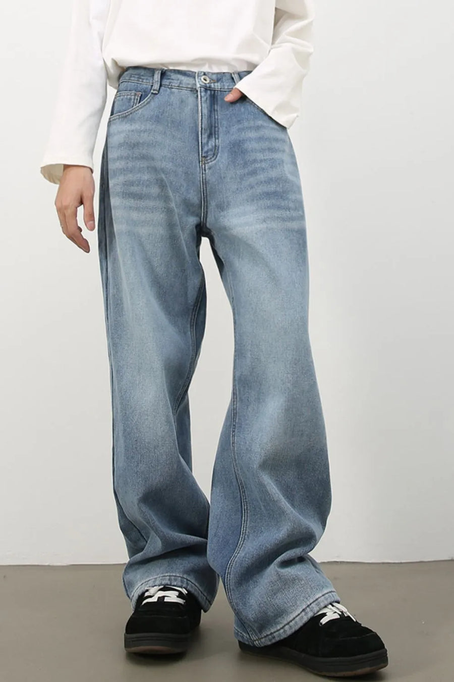 Oversized medium wash denim jeans with a fade effect, wide leg and relaxed fit.