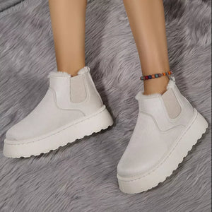 Beige suede round toe platform ankle boots with faux fur trim and elastic gore.