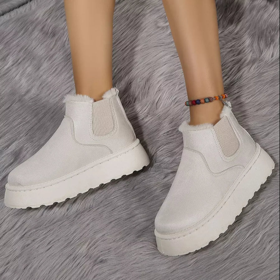 Beige suede round toe platform ankle boots with faux fur trim and elastic gore.