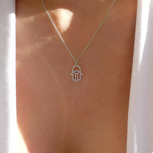 Silver Evil Eye Hamsa necklace with rhinestone details.