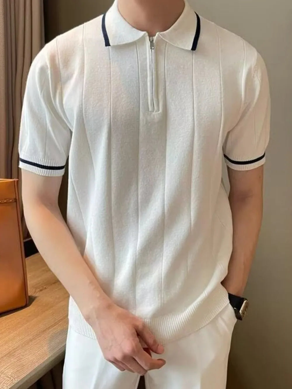 Textured ribbed polo shirt in ivory with contrast trim and quarter zip neckline.