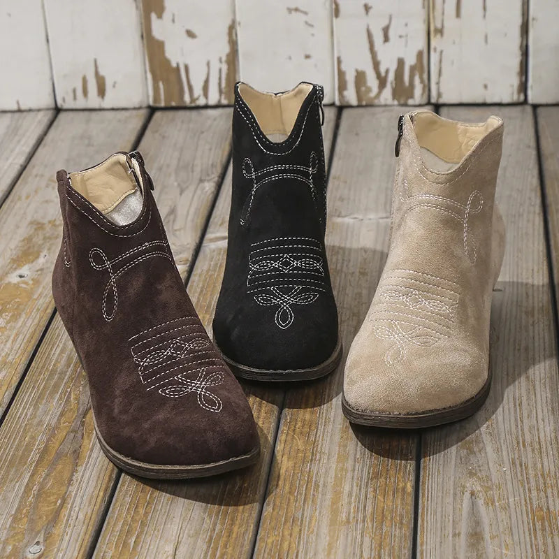 Embroidered suede western ankle boots in chocolate, black, and khaki with white stitching detail.