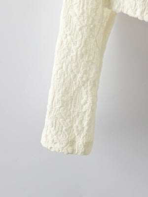Cream lace button-up cardigan with textured floral pattern detail.