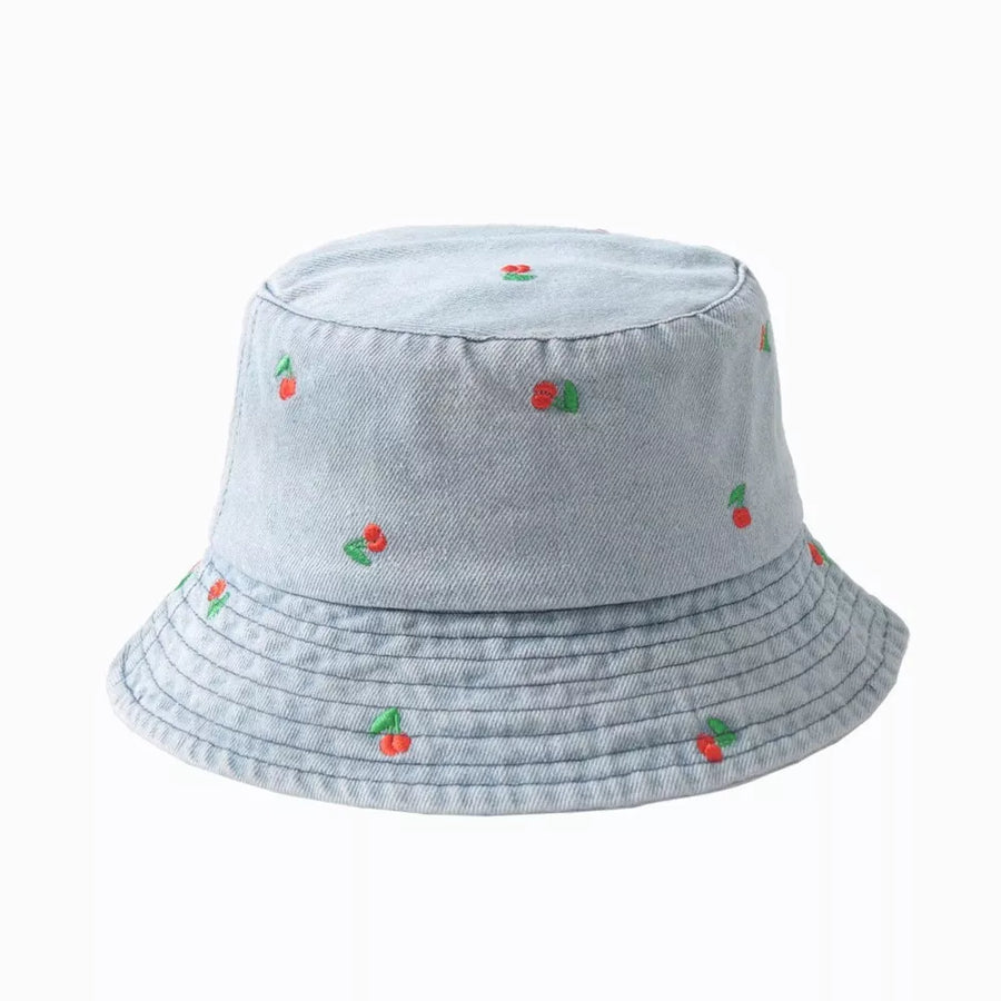 Light wash denim bucket hat with allover red cherry embroidery and stitched brim detail.