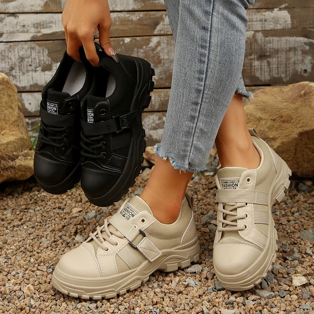 Beige and black lace up platform casual sneakers with chunky soles.