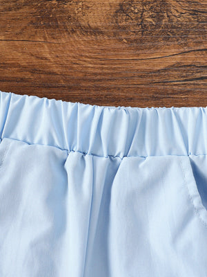 Light blue cotton baby shorts with elastic waistband and pocket detail.