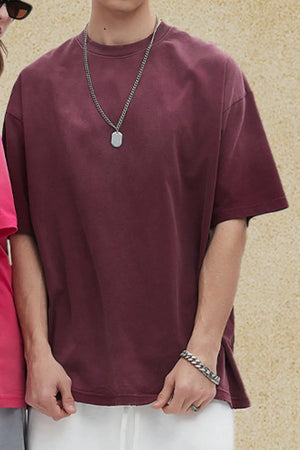 Oversized washed cotton crewneck tee in plum purple with a relaxed fit and short sleeves.