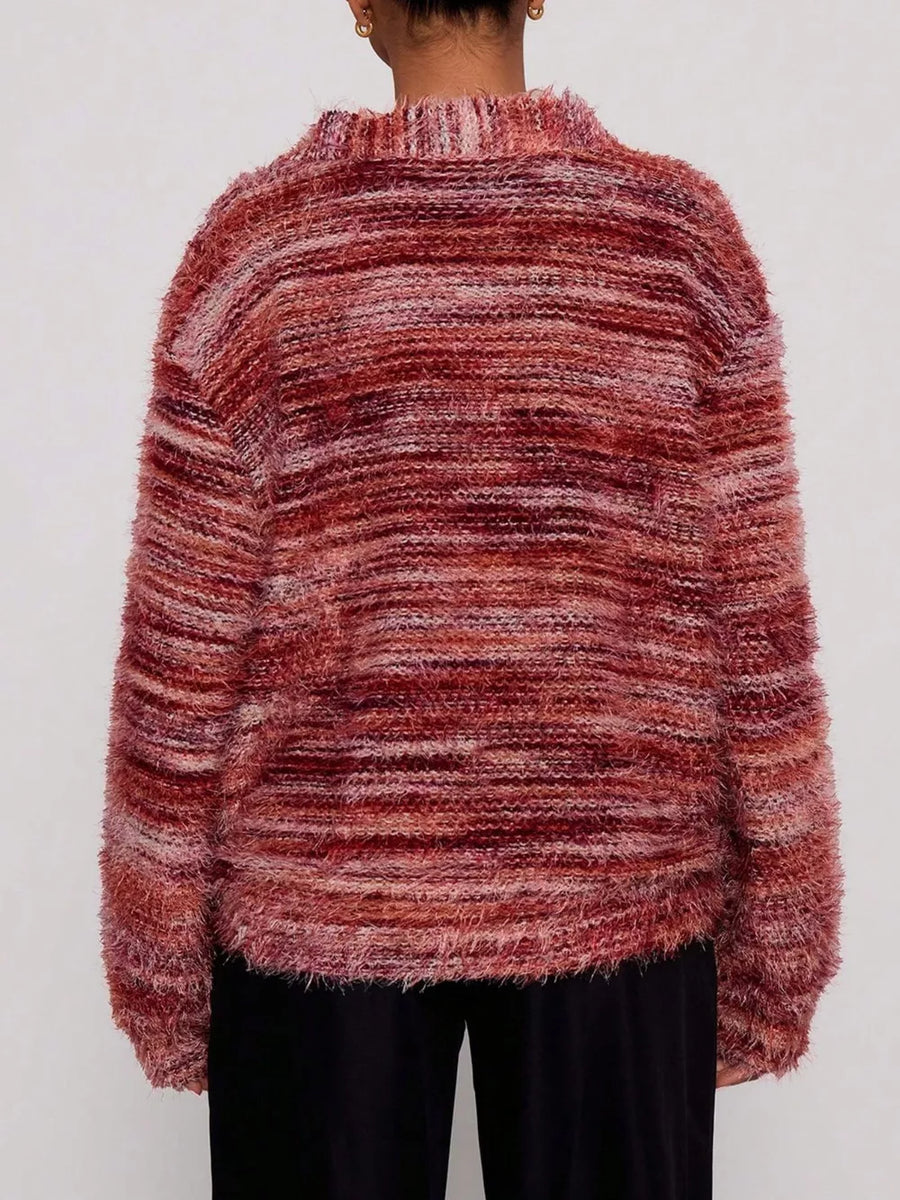 Cozy textured knit cardigan in a marled rust and pink blend with a fuzzy finish and ribbed neckline.