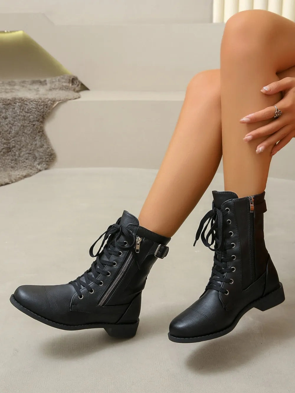 Black combat boots with lace-up front and side zipper detail