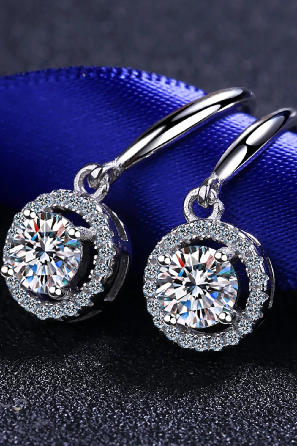 Silver moissanite halo drop earrings with sparkling round-cut center stones.