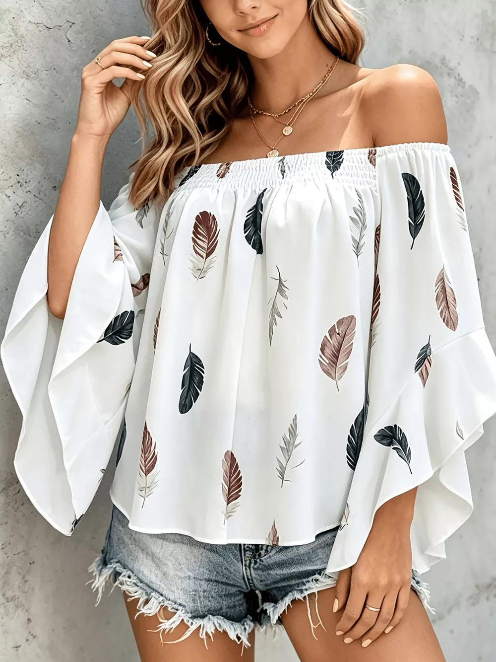 White off-shoulder top featuring smocked and feather-print