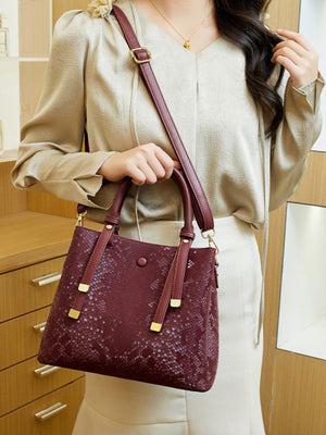 Wine Red handbag featuring top handles and snakeskin