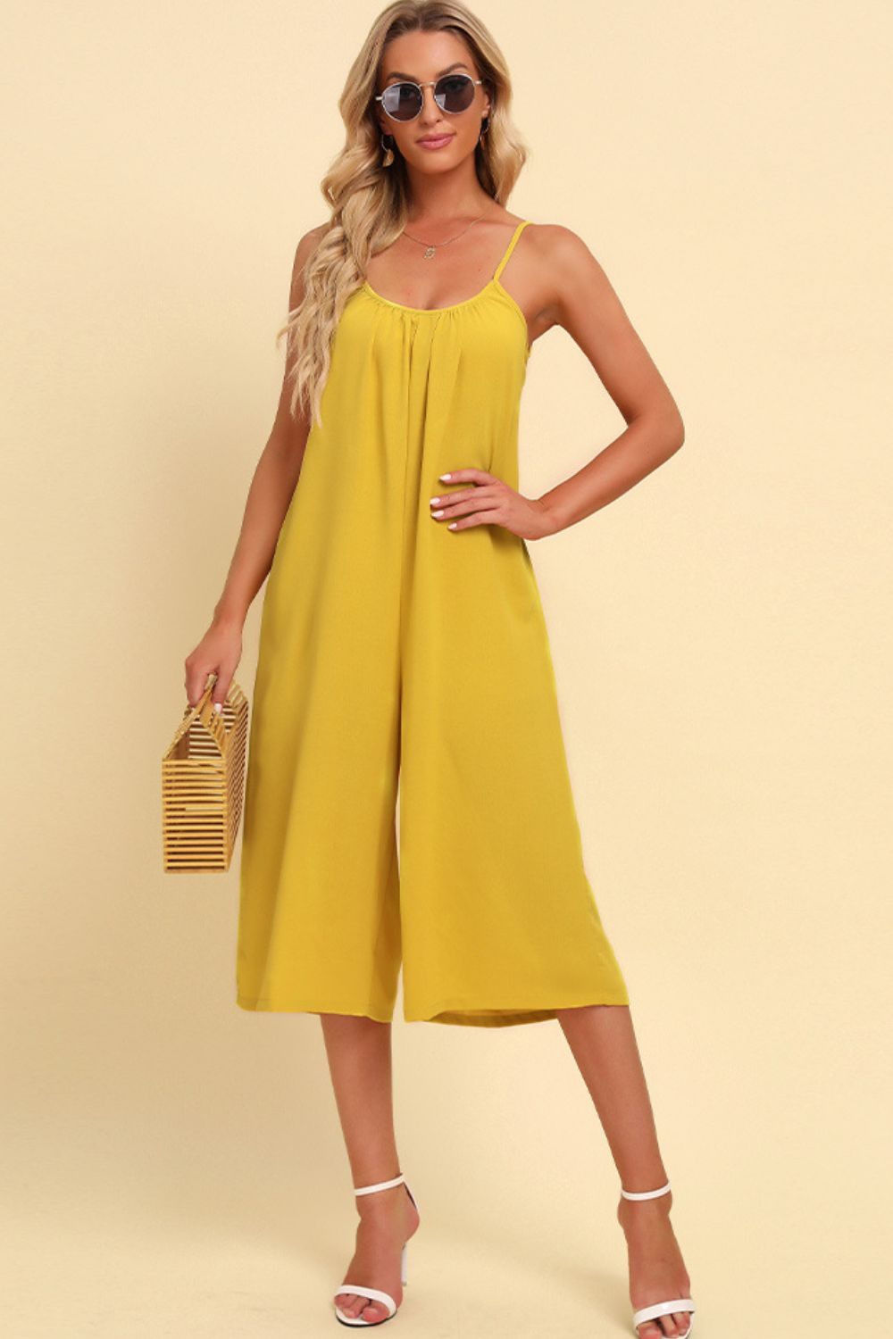 Yellow culotte jumpsuit with gathered bodice and spaghetti straps.