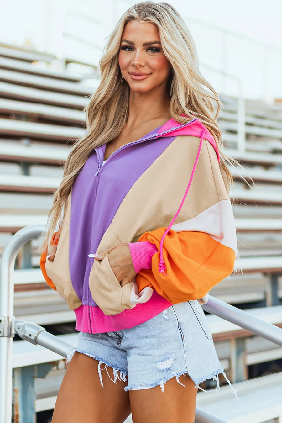 Colorblock zip-up hoodie with balloon sleeves in purple, tan, orange, and pink.