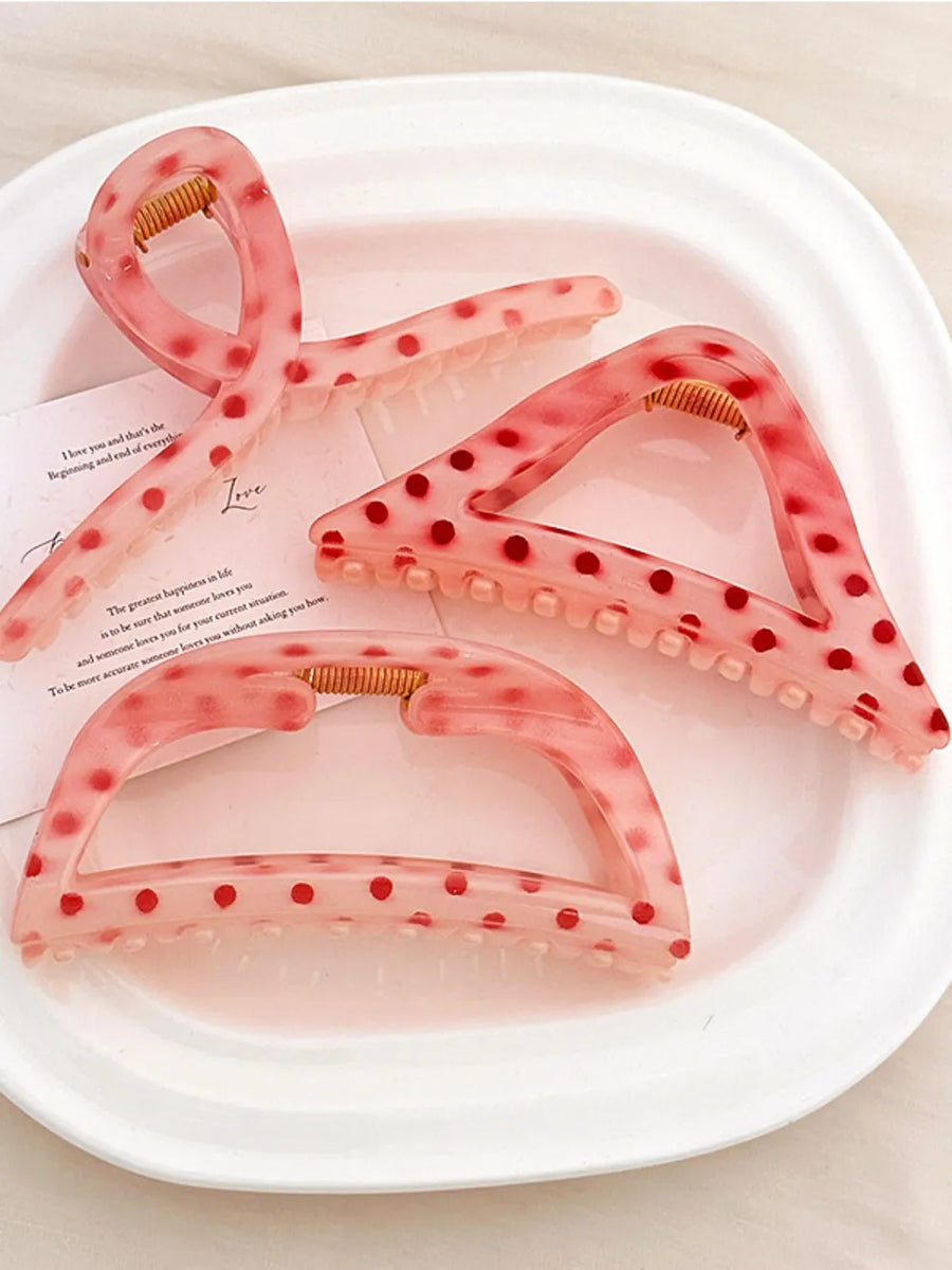 Polka dot claw hair clips in pink with red dots, available in Style A, B, and C.