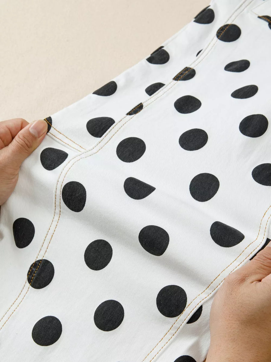 White denim jeans with black polka dots and contrast stitching.