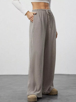 Relaxed wide-leg pants in mocha with drawstring and pockets, ribbed knit fabric.