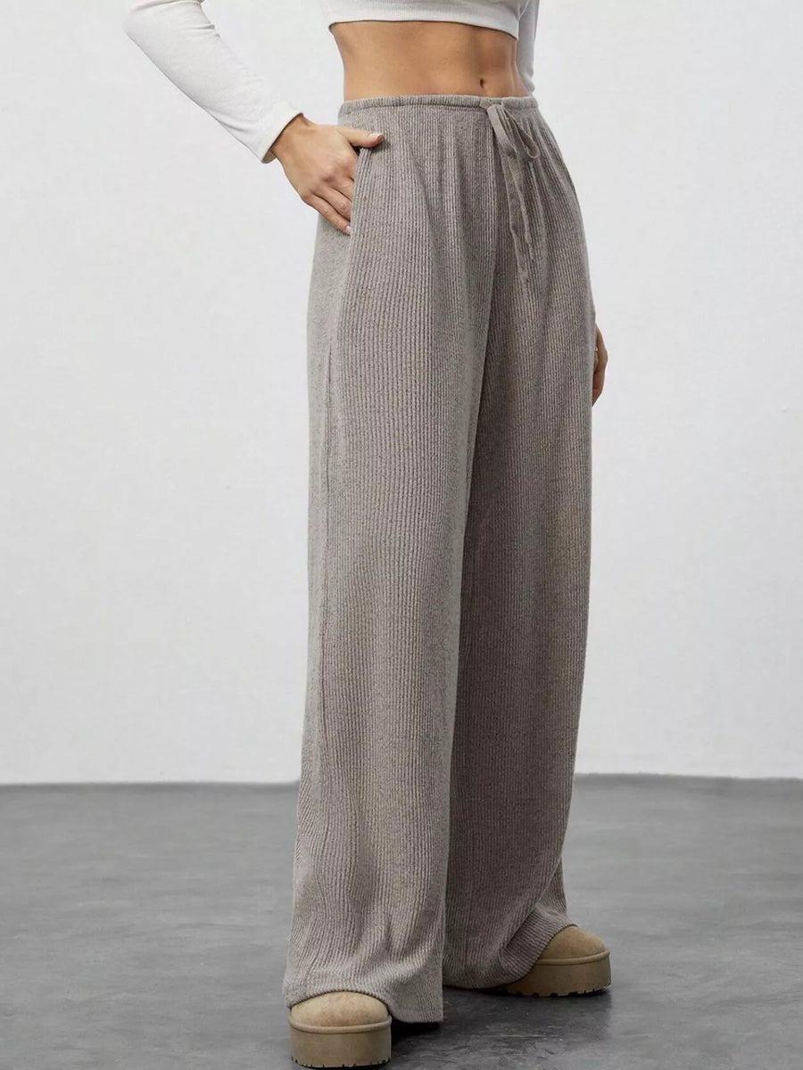 Relaxed wide-leg pants in mocha with drawstring and pockets, ribbed knit fabric.