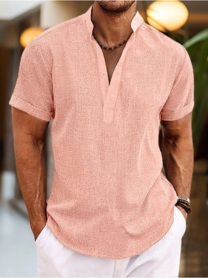 Men's pink short sleeve casual henley shirt with buttoned placket and textured fabric.