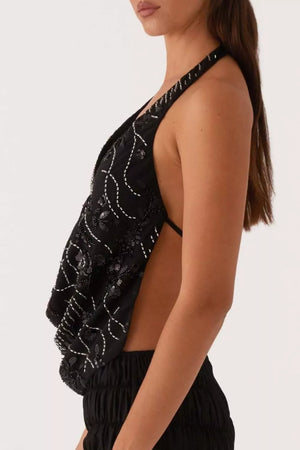 Black sequined halter top with white stitching detail and open back.