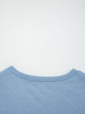 Light blue textured drawstring set with crew neck and geometric pattern detail.