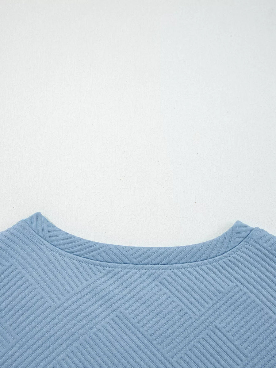 Light blue textured drawstring set with crew neck and geometric pattern detail.