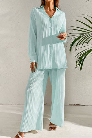 Pleated co-ord set in pastel blue featuring a button-down shirt and wide-leg trousers.