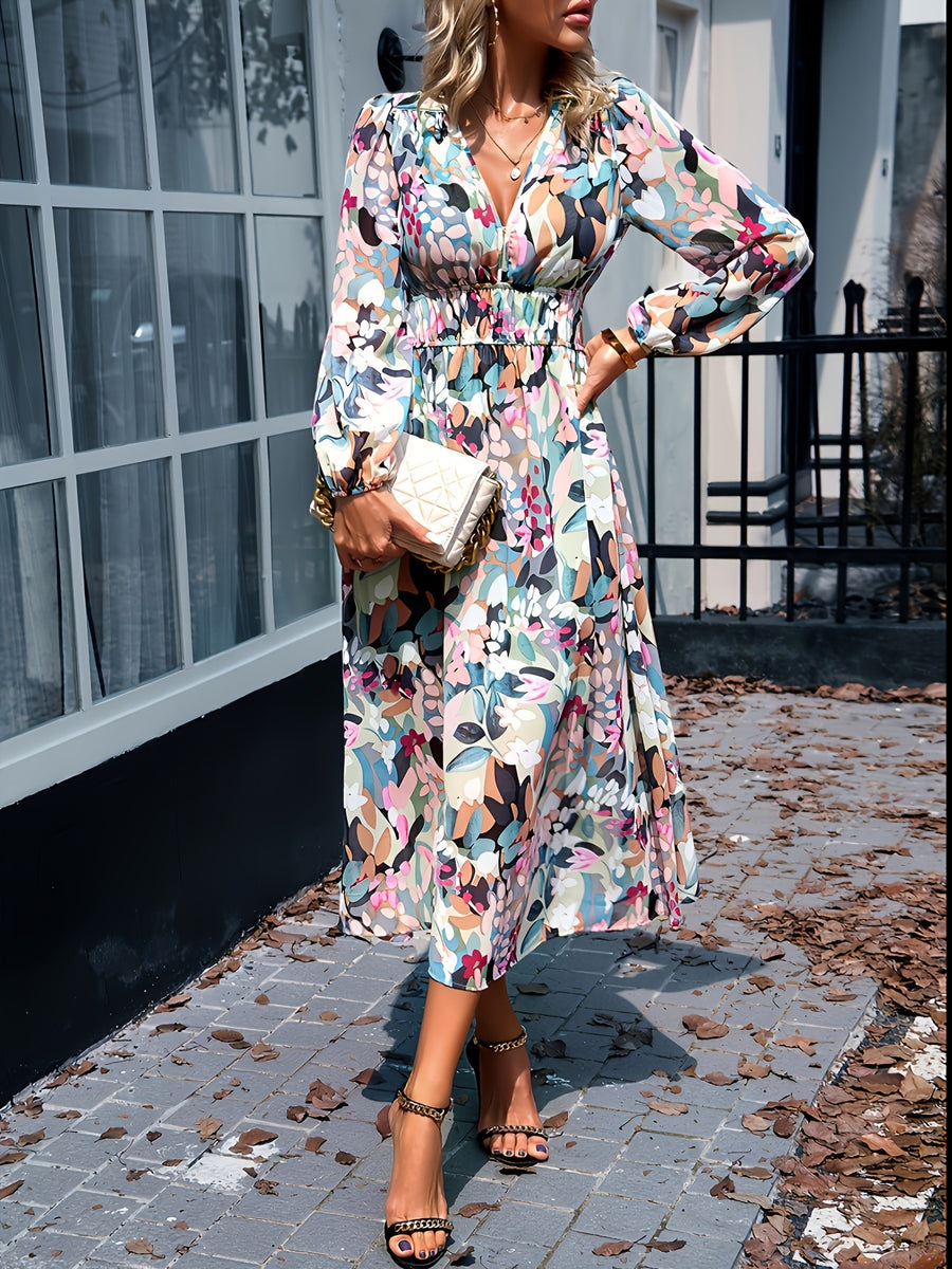 Floral print midi dress with V-neck, long sleeves, and smocked waist.