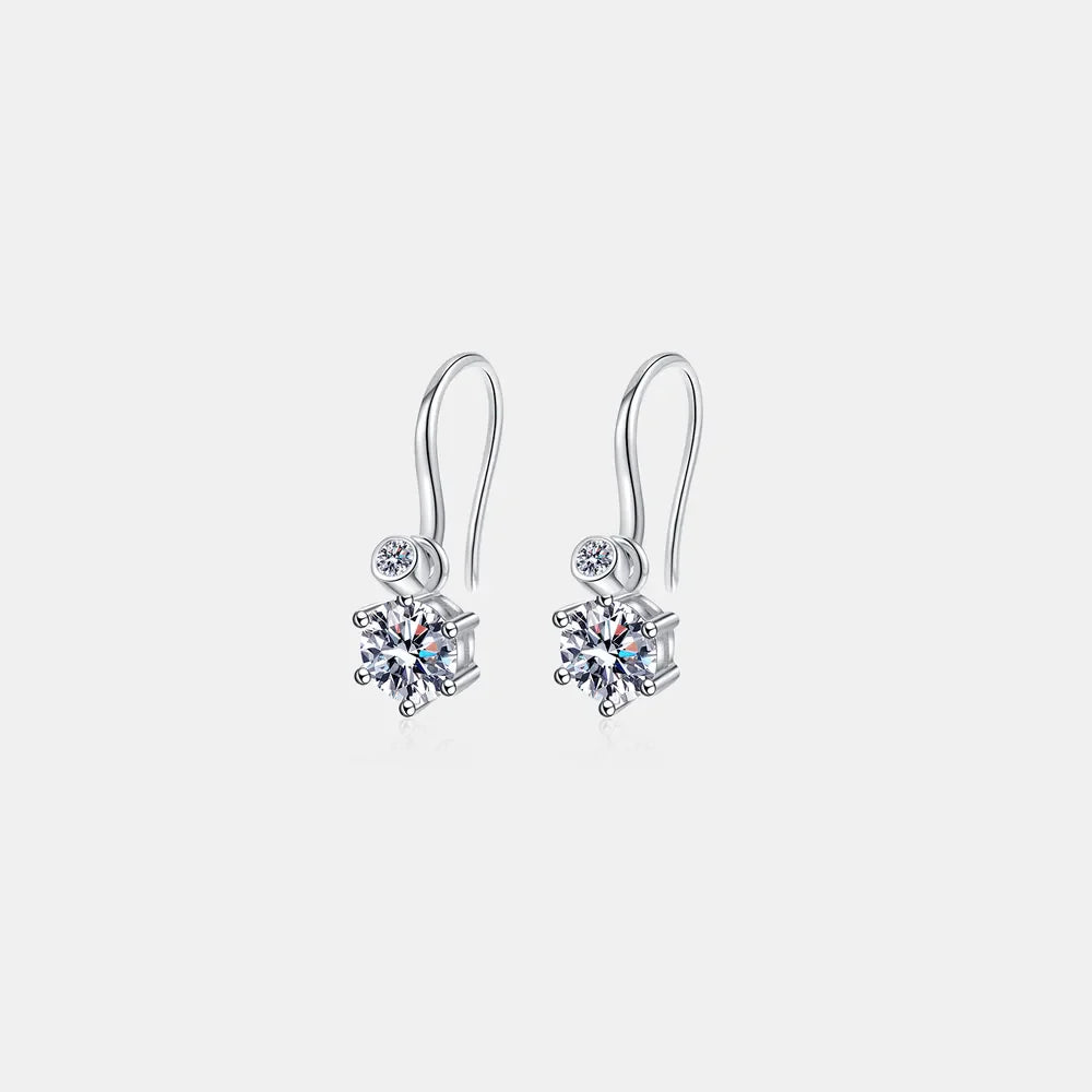 Silver drop earrings with a large solitaire stone and a smaller accent stone.