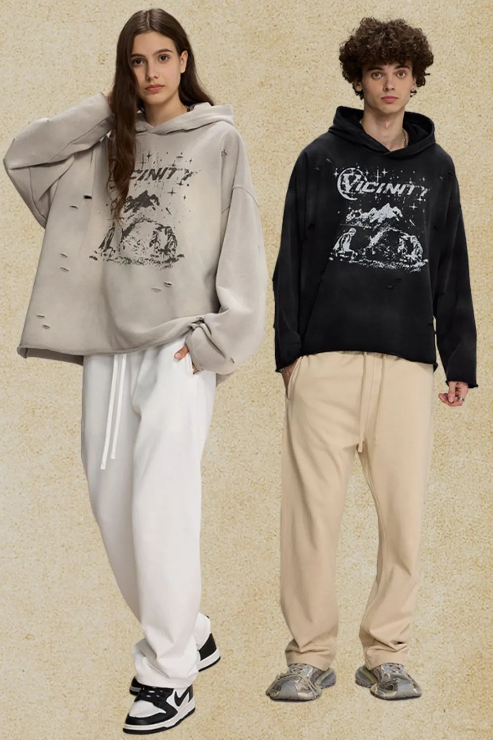 Distressed graphic oversized hoodie in black and gray with ripped details and a bold print.