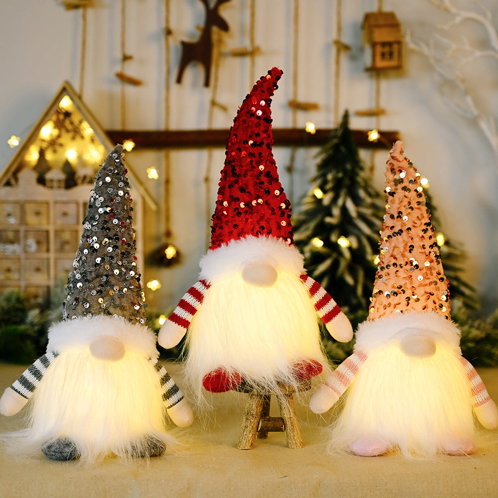Light-Up Sequin Gnome Trio in dark gray, red, and blush pink with fuzzy bodies and striped sleeves.