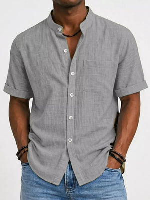 Light gray textured band collar button-up shirt with cuffed short sleeves and a chest pocket.