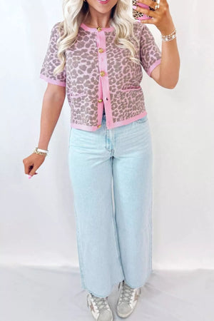 Short sleeve leopard print cardigan with pink trim and gold buttons, acrylic blend.