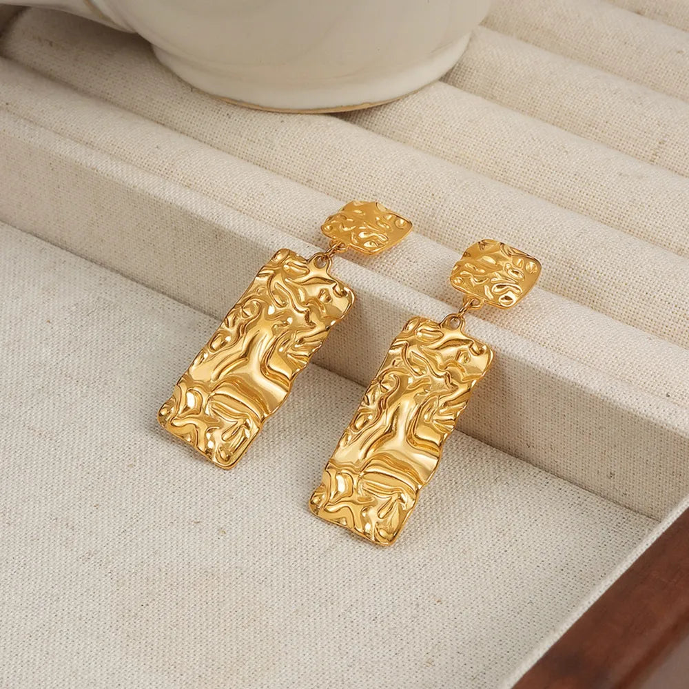 Sculptural gold-plated crinkle rectangle drop earrings with textured square tops.