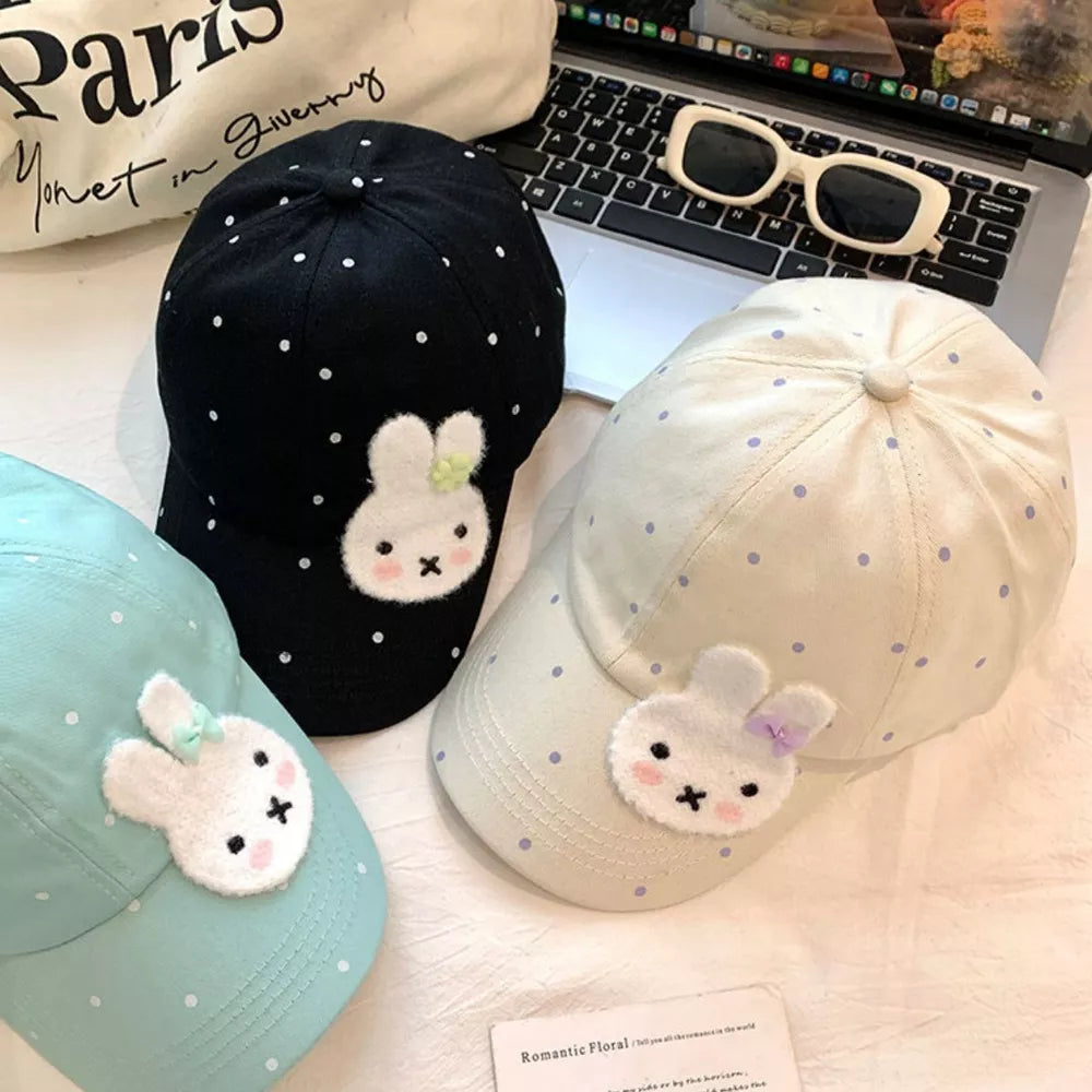 Bunny polka dot baseball cap with applique in black, ivory, and pastel blue.