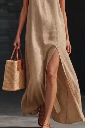 Khaki V-neck maxi dress with high slit, sleeveless, and side pocket detail.