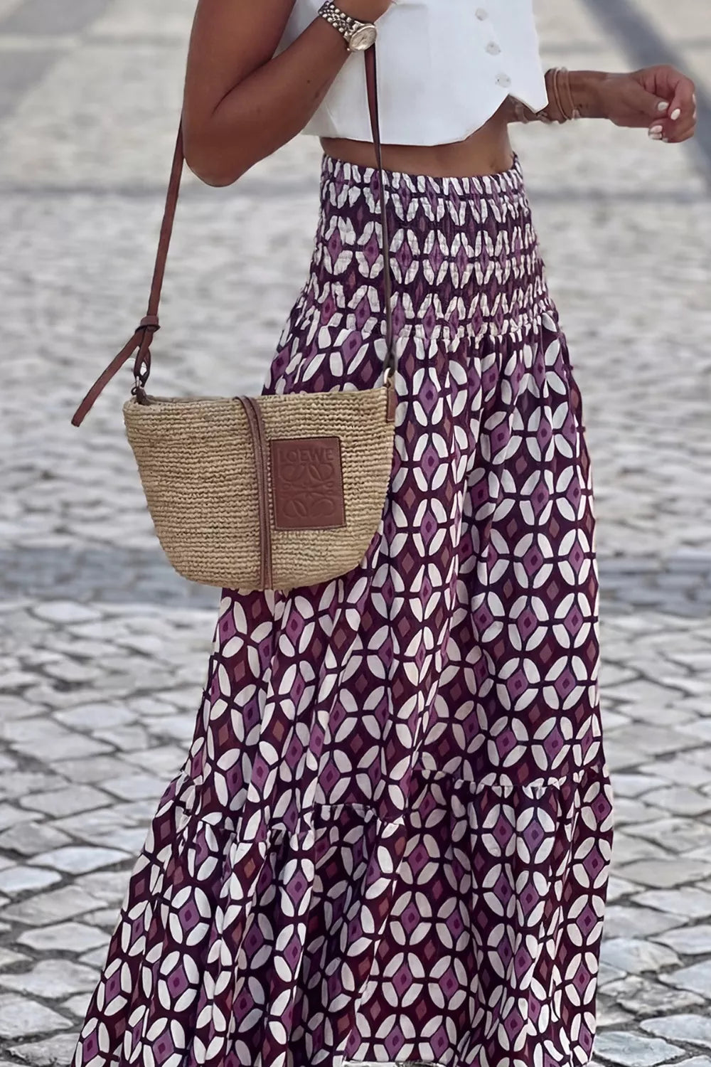 Maxi skirt with smocked waist and geometric print in purple and white.
