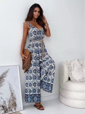 Paisley patterned white and blue tied wide-leg romper with a belted waist.