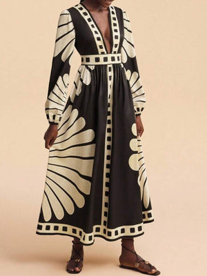 Maxi dress with deep V-neck, long sleeves, and bold black and cream geometric print.